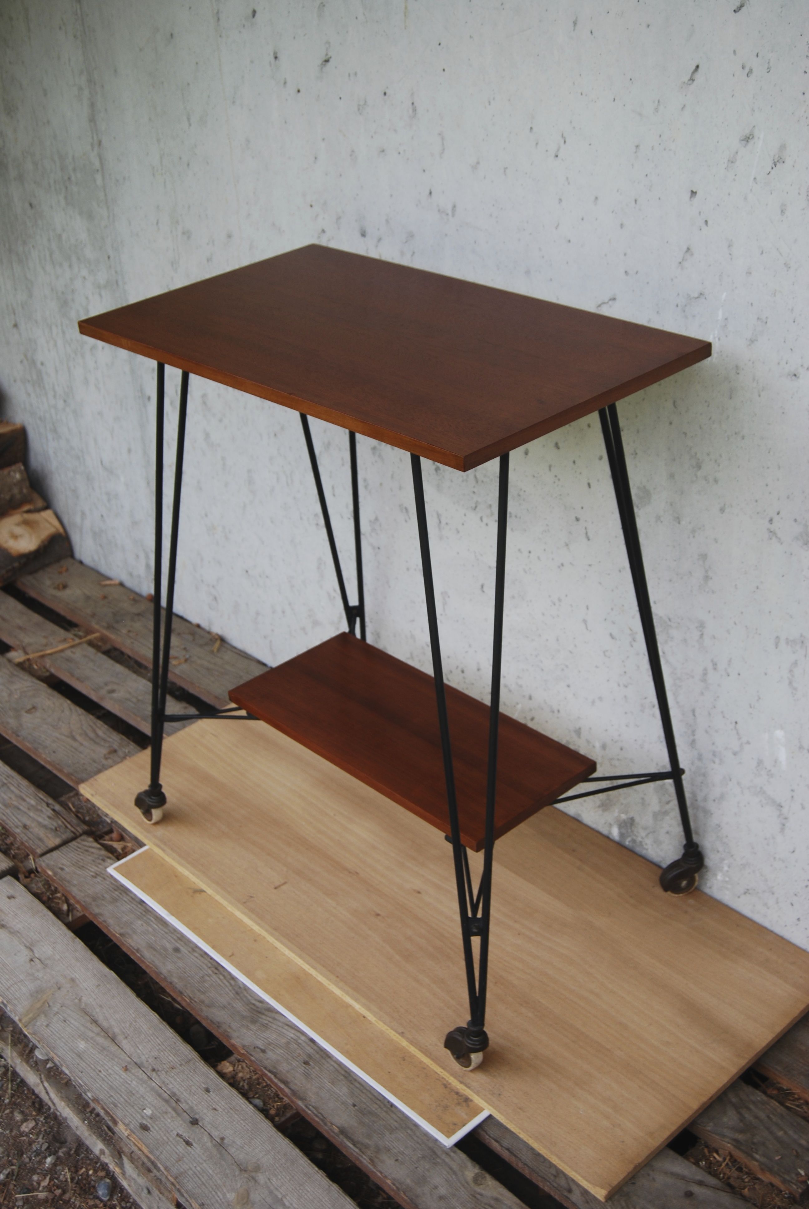 Tv furniture, a table with teak wheels and Scandinavian-style metal.