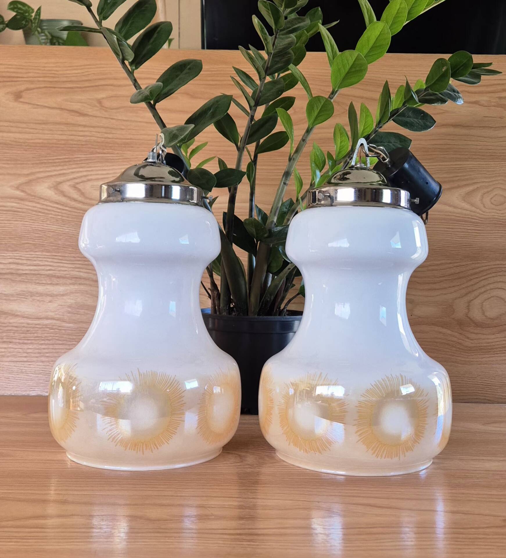2 vintage pendant lights in white opaline with orange patterns and chrome.