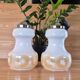 2 vintage pendant lights in white opaline with orange patterns and chrome.