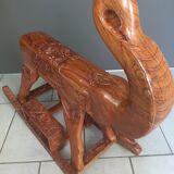 Decorative rocking elephant in carved exotic wood.