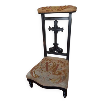 Blackened wooden prayer table with cross