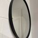 Round mirror 75cm in diameter with a black frame.