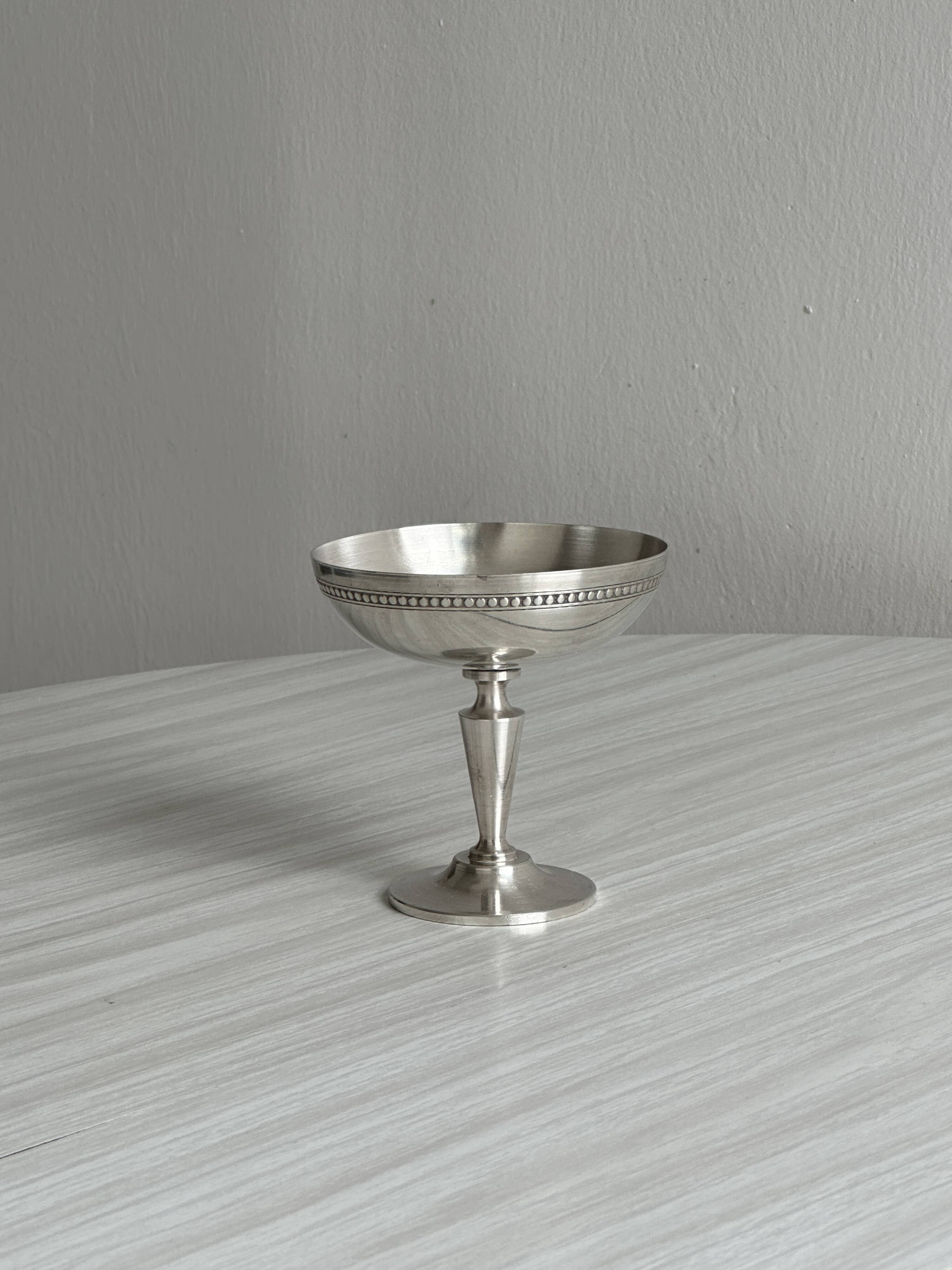 Silver-plated metal bowl on a stand