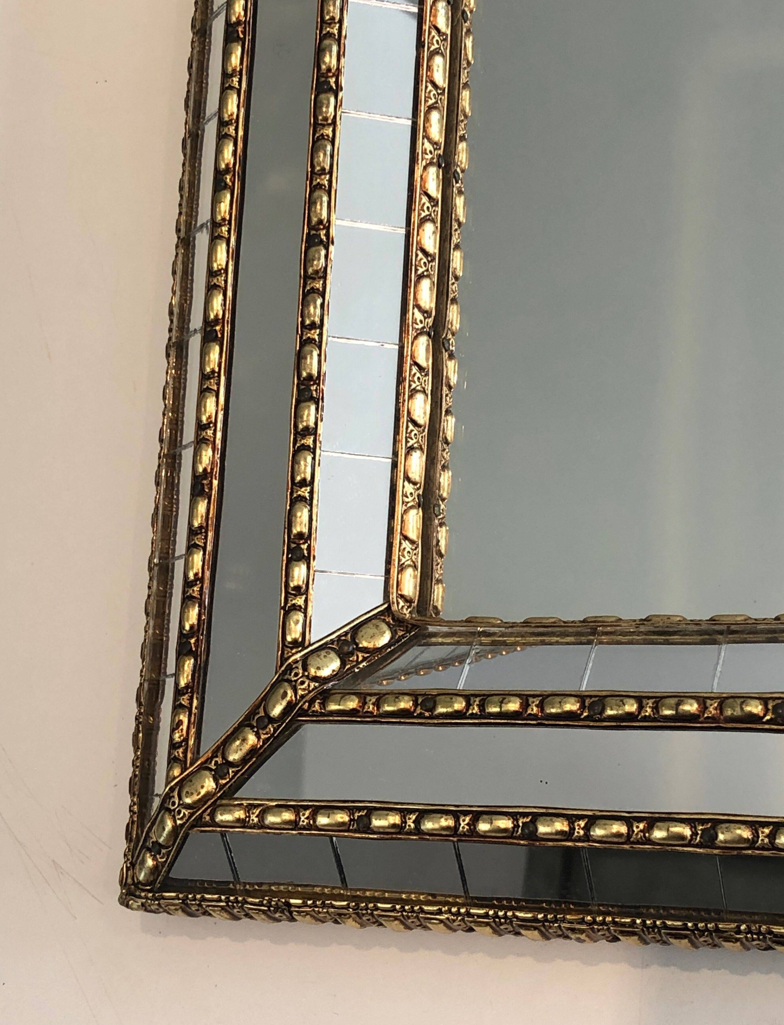 Multi-faceted mirror and brass garlands
