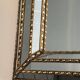 Multi-faceted mirror and brass garlands