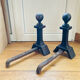 Pair of massive antique-style fire dogs in solid iron from the 20th century.