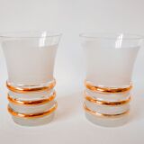 set composed of a pitcher and two large white granite glasses with gold edging from the 60s
