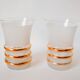 set composed of a pitcher and two large white granite glasses with gold edging from the 60s