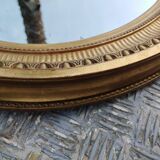 Antique oval mirror in gilded stucco with gold leaf, 19th century