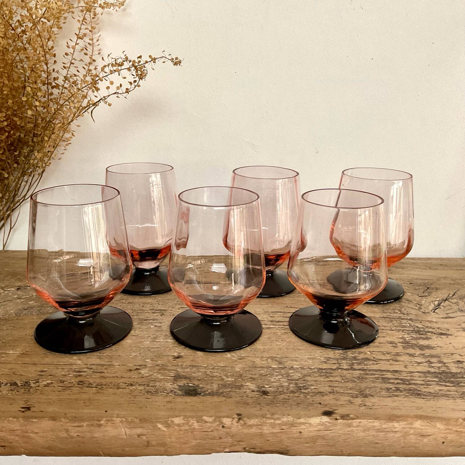 6 small pink glasses with black stem