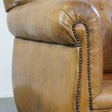 Fauteuil ancien en cuir de mouton
