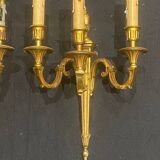 Pair of gilt bronze wall sconces with three lights in the Louis XVI style.