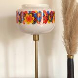 Table lamp with a vintage “flower power” glass globe and a gold base