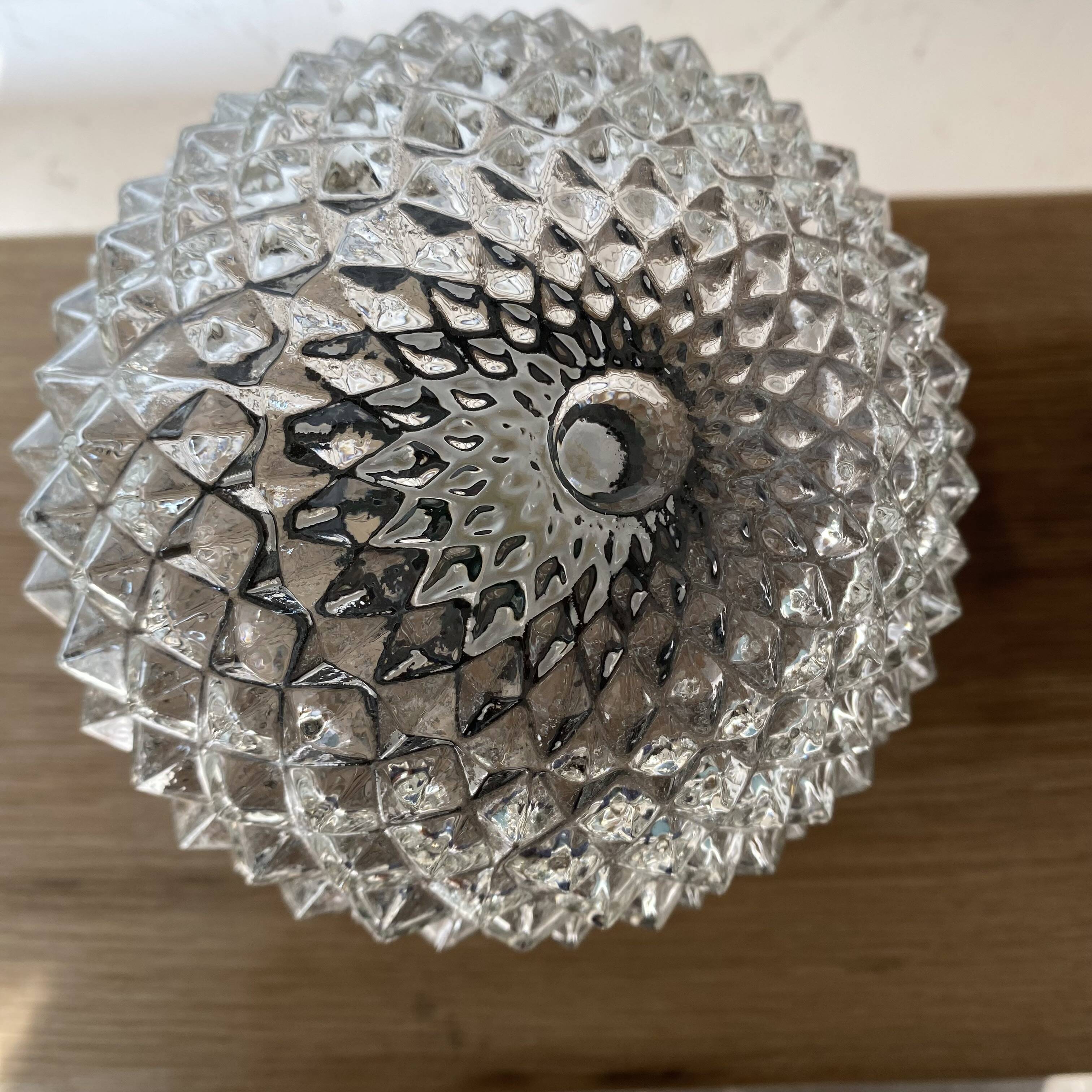 Pair of slanted glass wall lights with black plastic base, decorative v