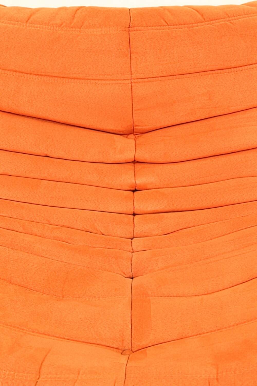 Togo sofa set and armchairs in pumpkin orange, 3 pieces, no label.
