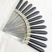 12 antique large table knives with ebony handles from the Napoleonic III period.