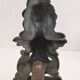 Pair of bronze andirons with black patina, 19th century, female caryatids