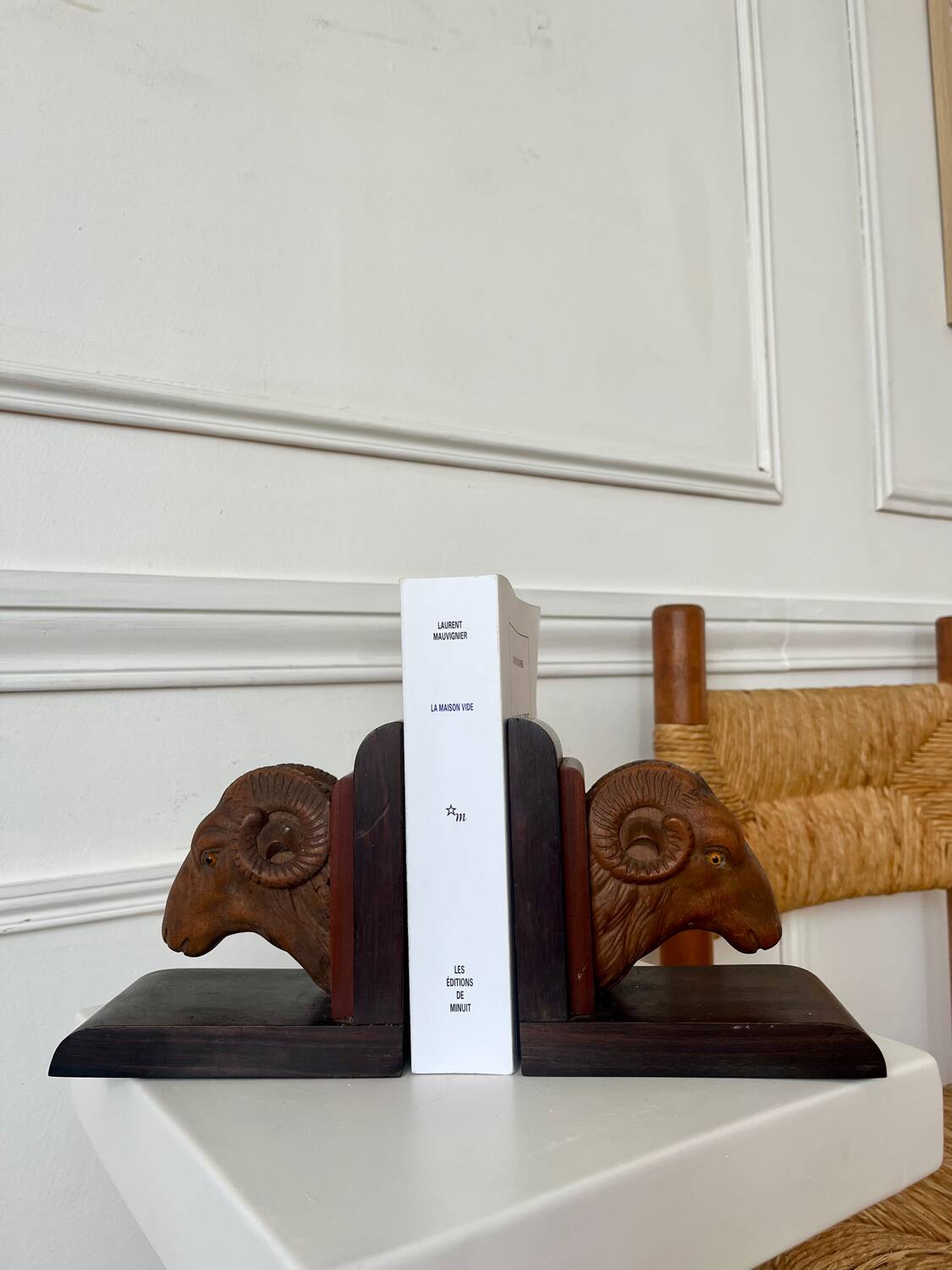 Pair of carved wooden bookends in the shape of ram's heads.