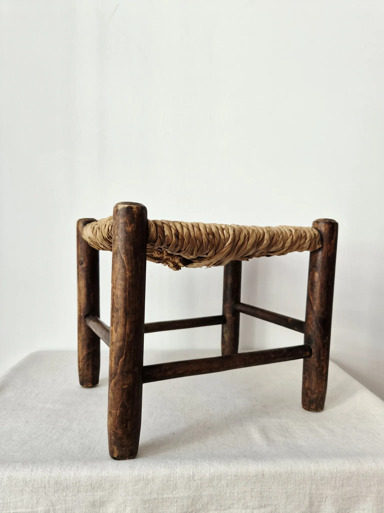 Small rustic vintage wooden and straw stool -