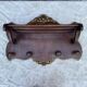 Coat rack and wall-mounted hat rack in an antique style.
