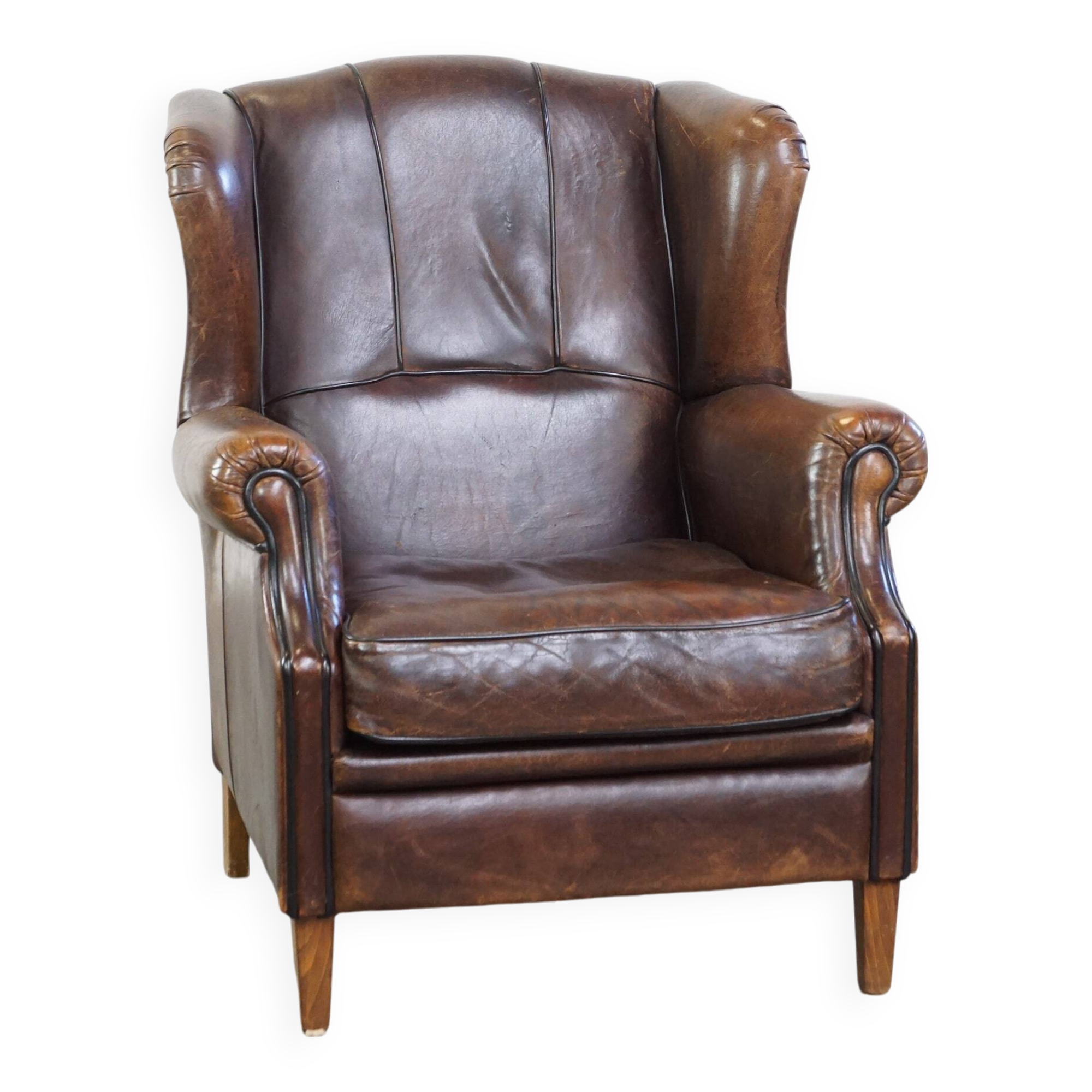 Wing chair made of sheepskin and neatly finished with black piping
