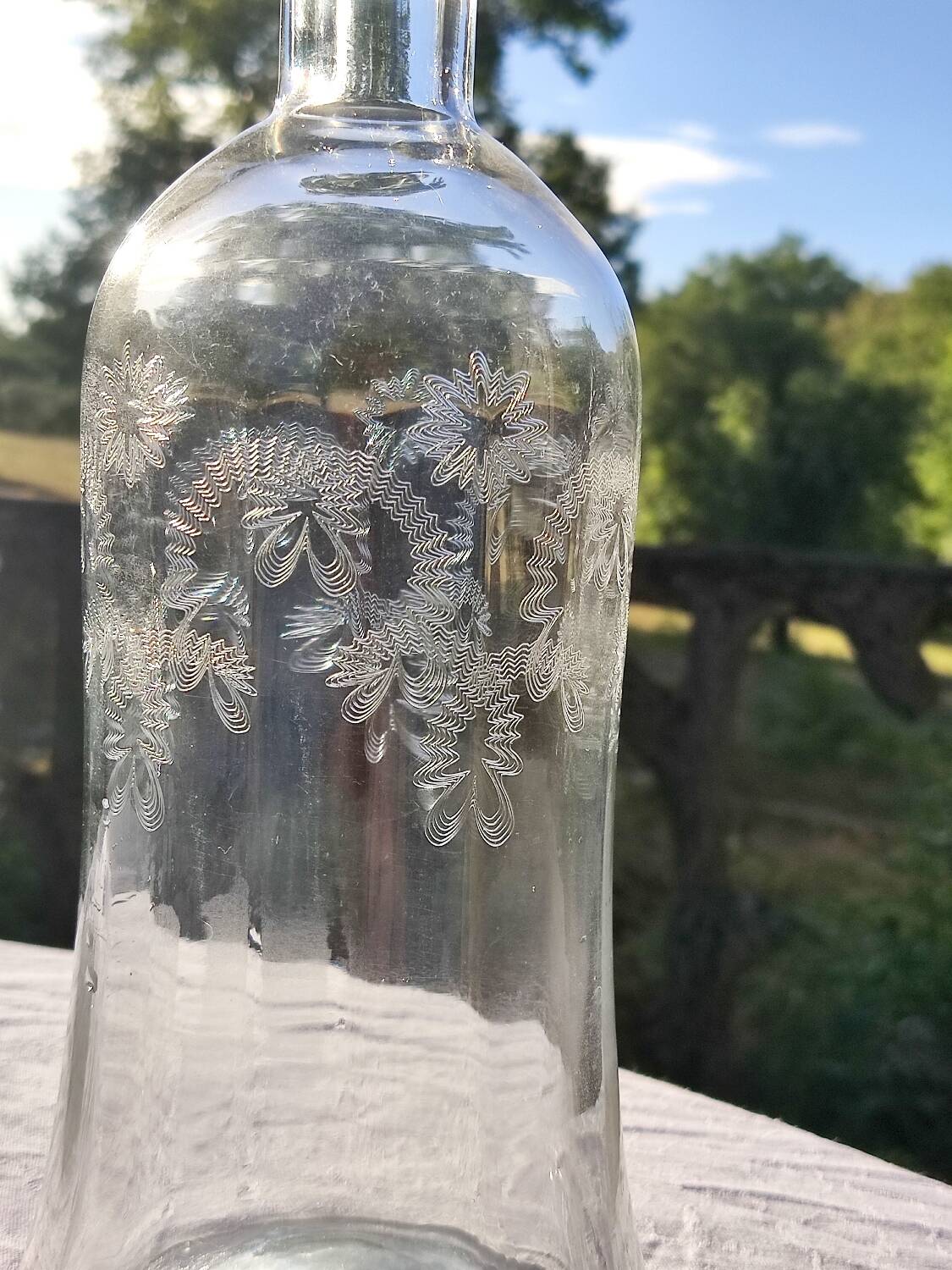 Two antique engraved glass bottles