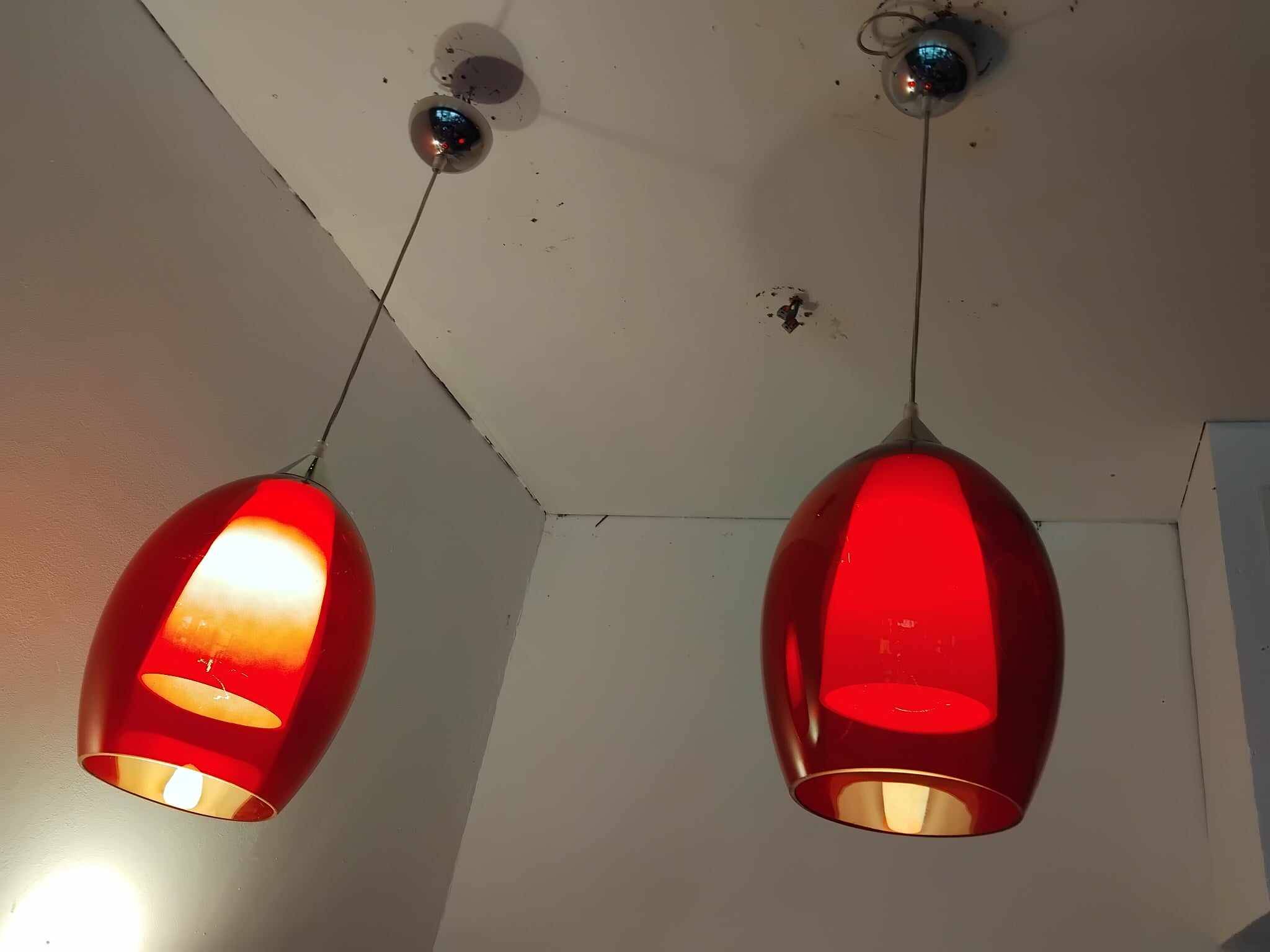 Pair of conical pendant lights in red tinted glass