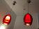 Pair of conical pendant lights in red tinted glass