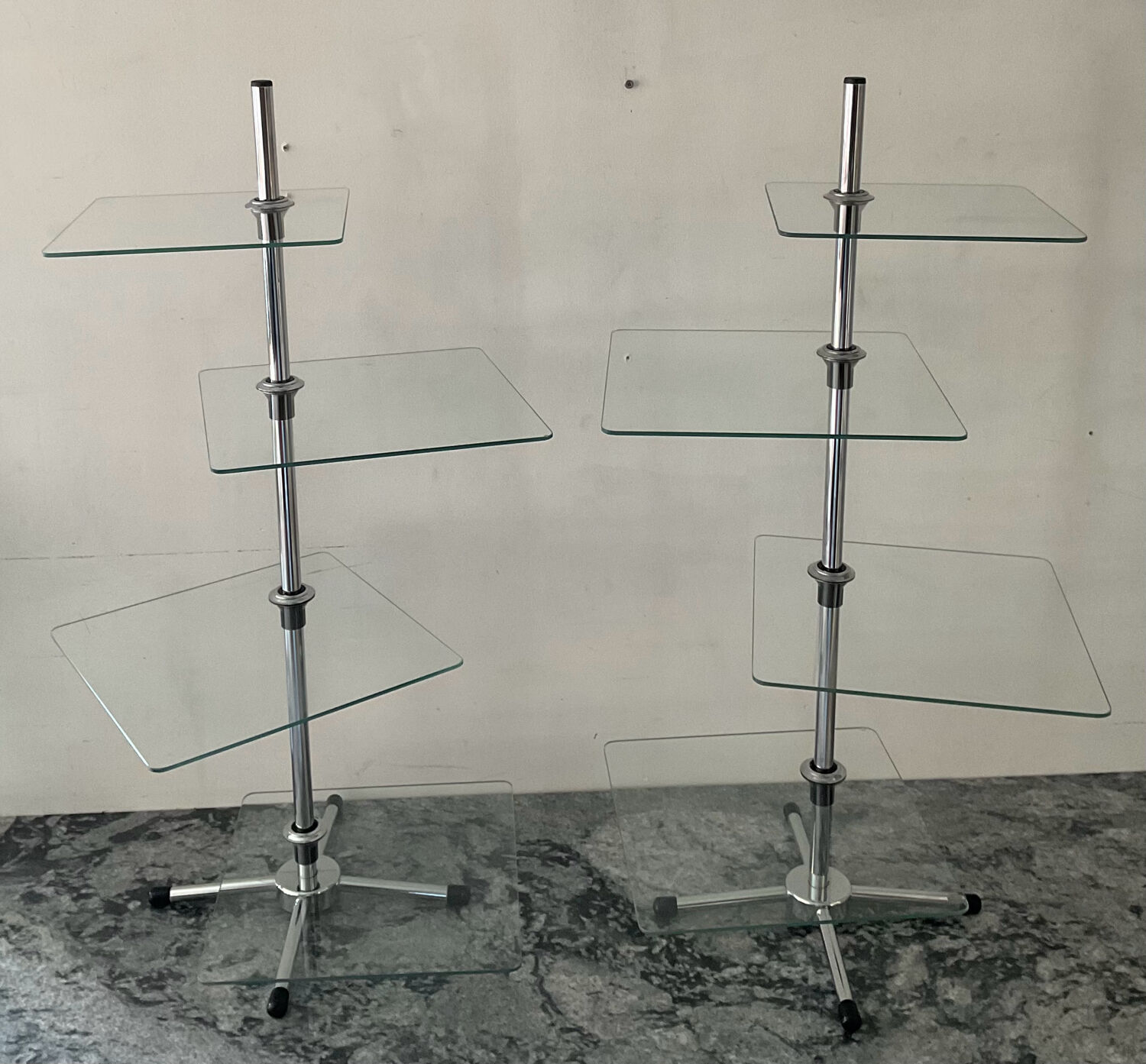 A pair of vintage side tables in glass and chrome metal.