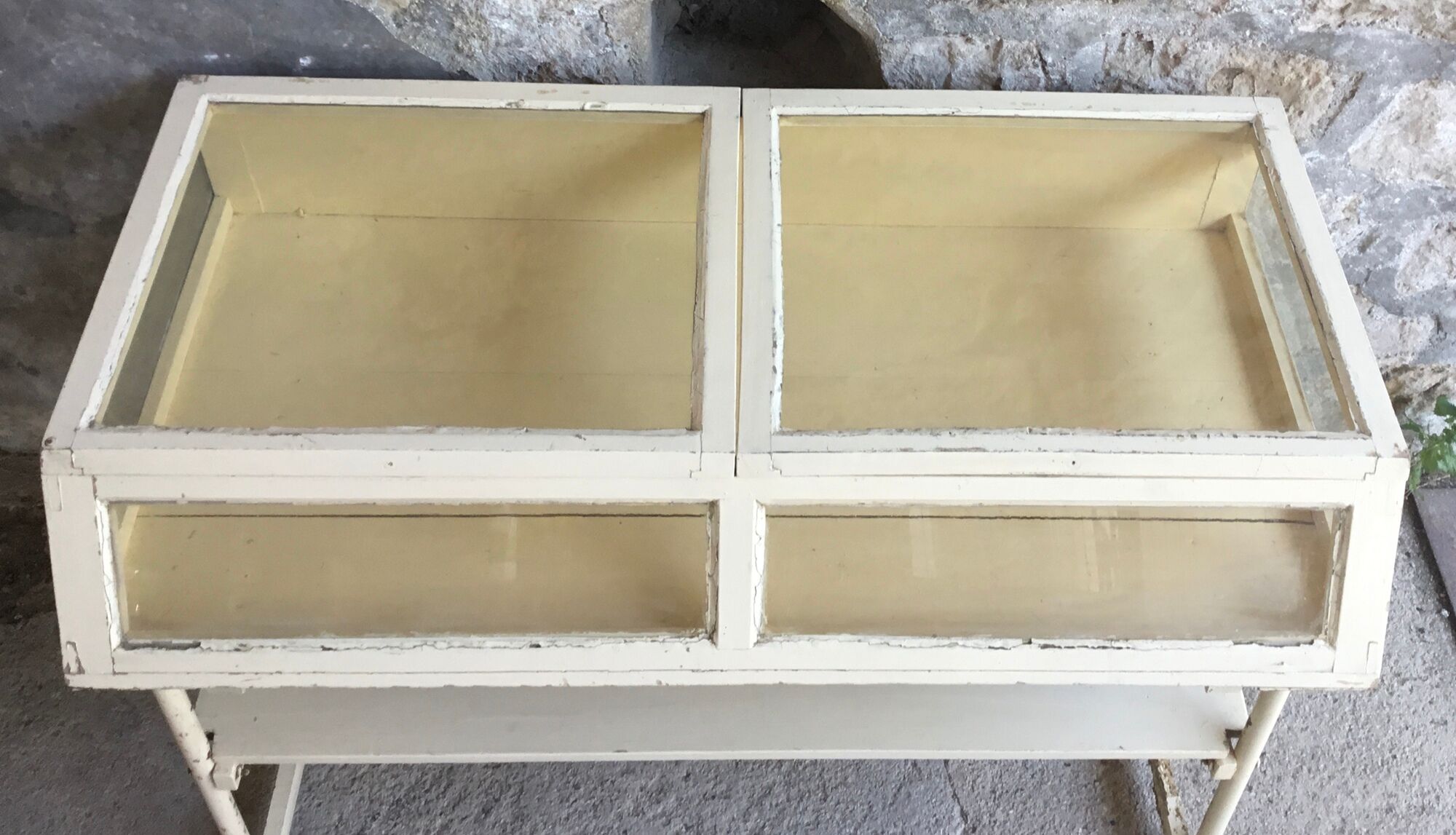 Old showcase on tubular metal feet - early twentieth century
