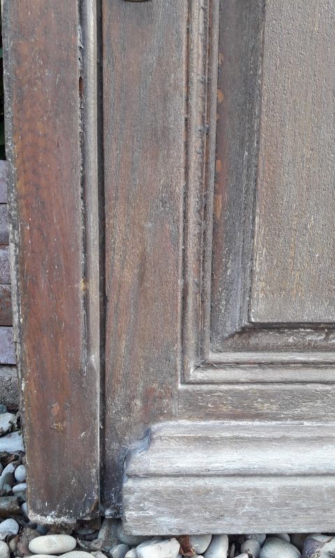 Oak entrance door and its frame and transom, wrought iron gates