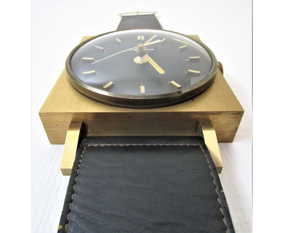 Horloge murale de forme montre bracelet noir et métal doré années 60 |  Selency