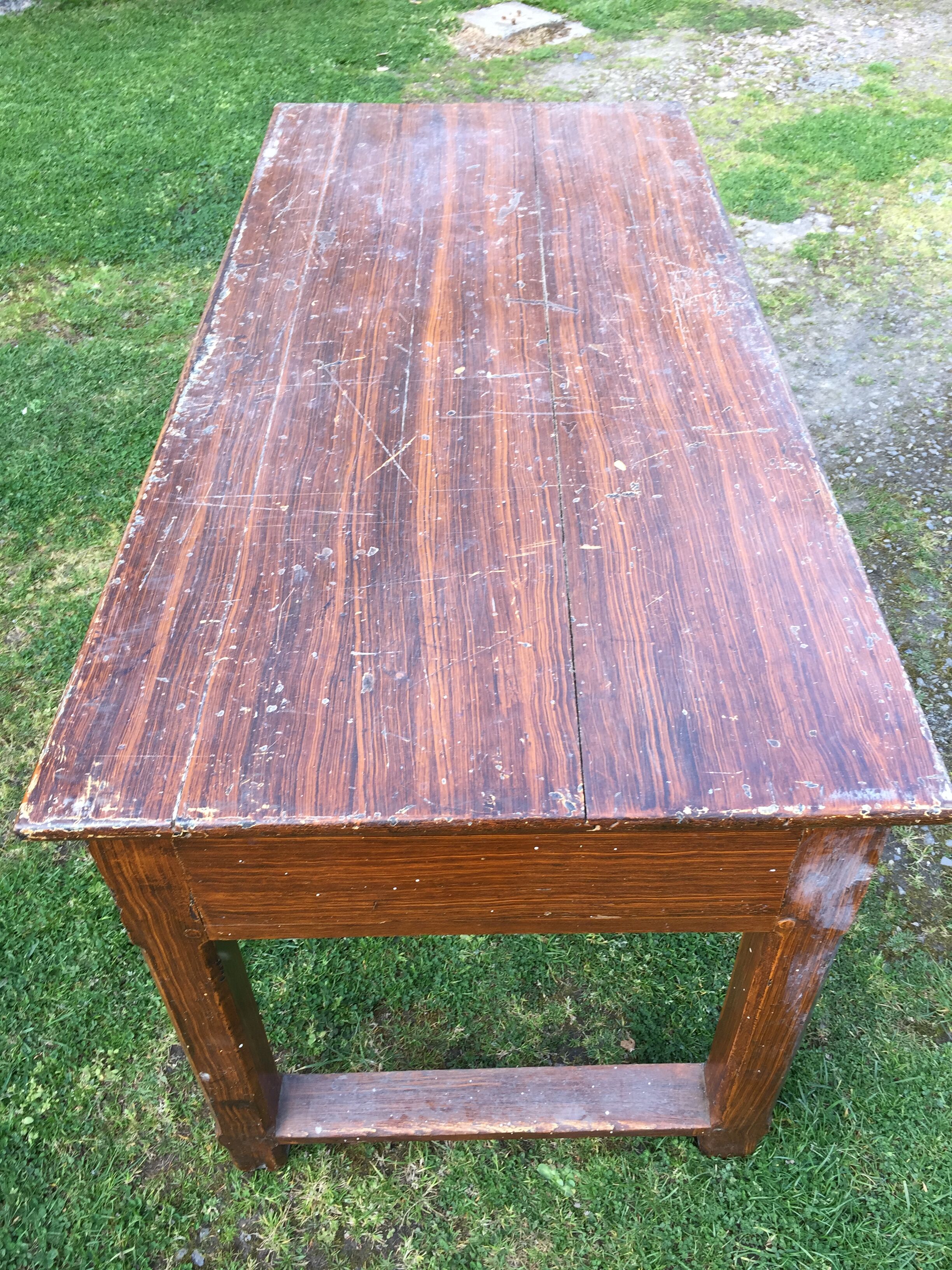 Old farmhouse table in oak painted faux wood old painting.