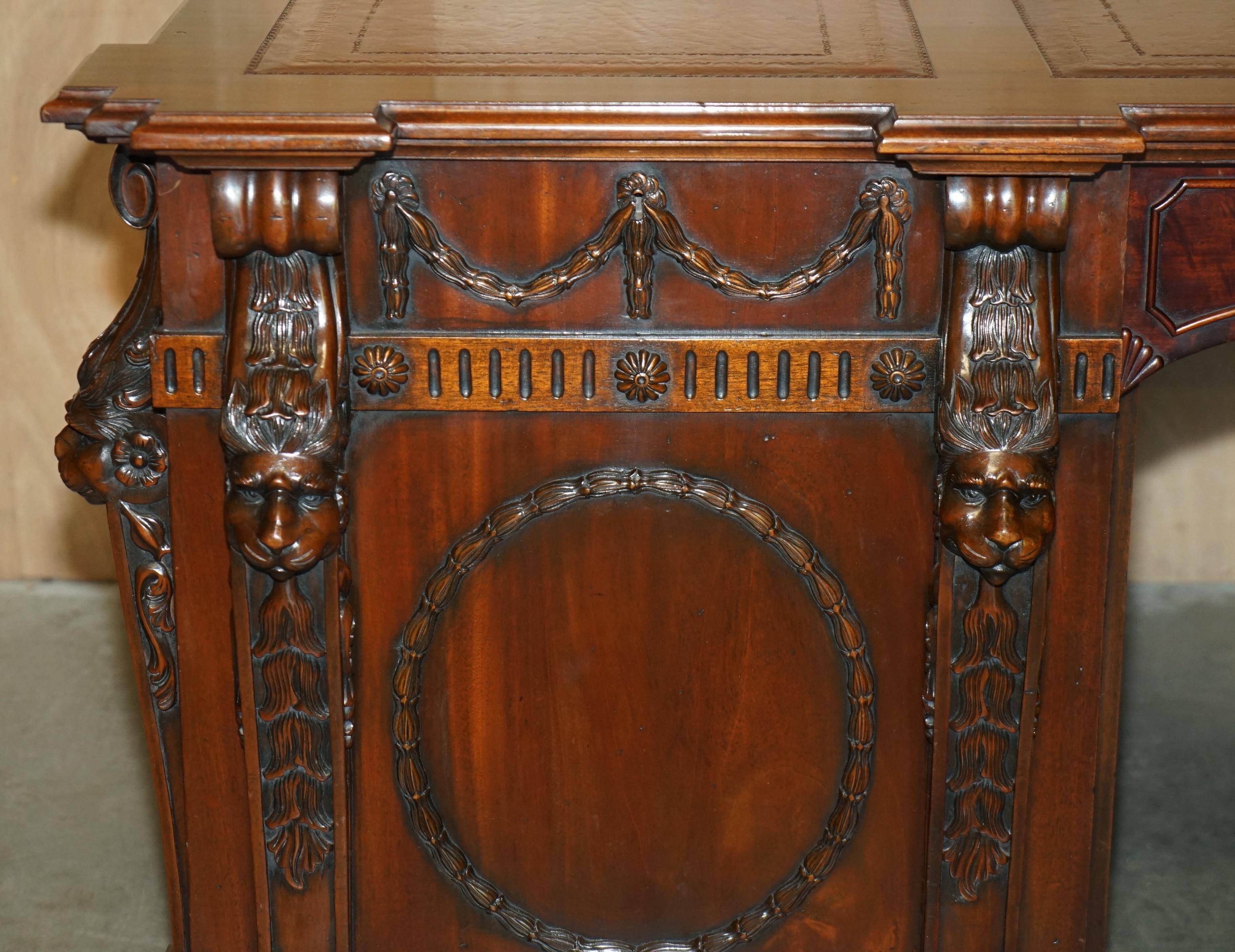 Partner desk with two carved columns featuring lion heads, according to Thomas Chippendale, restored.