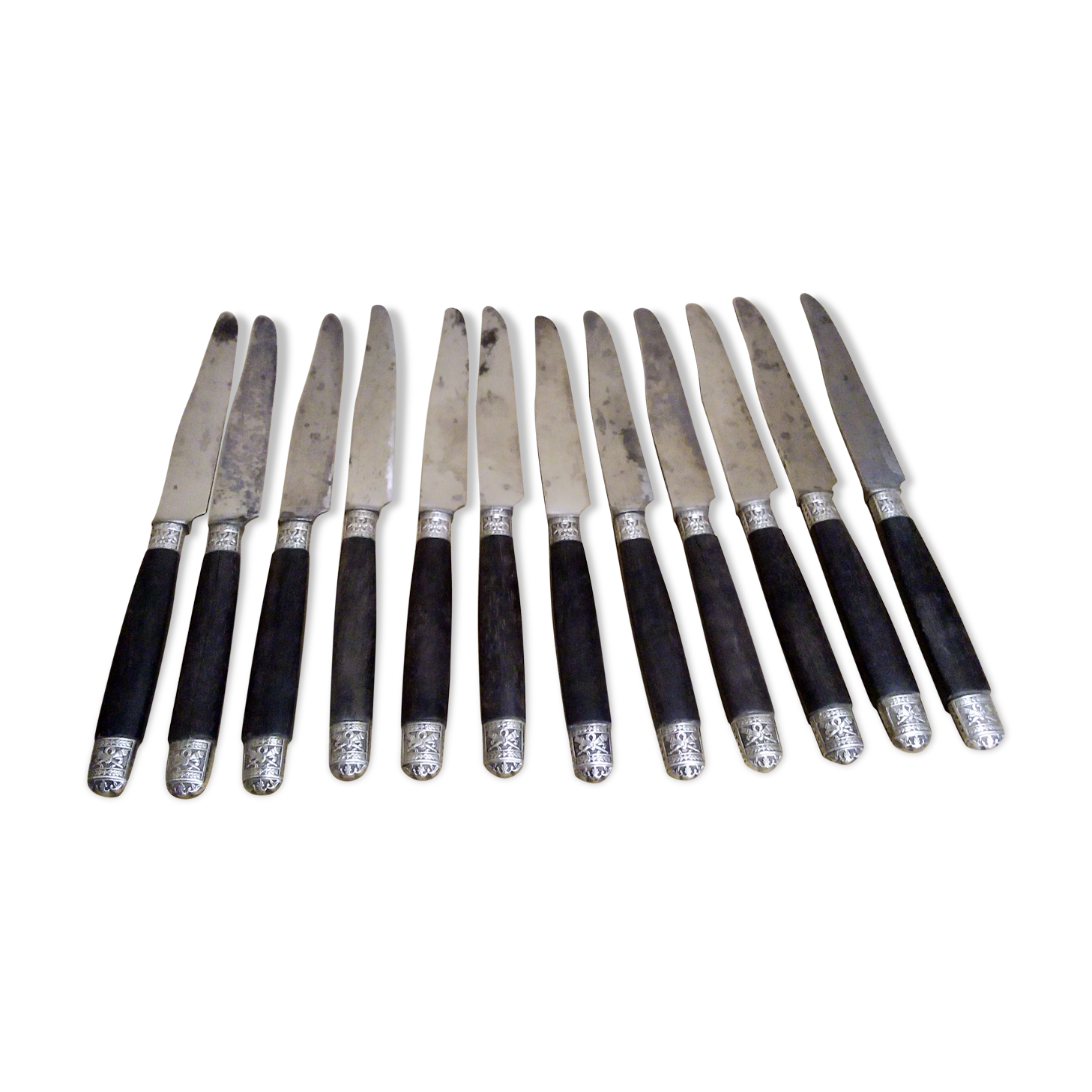 12 Silver dessert knives, ebony, steel, late 19th century