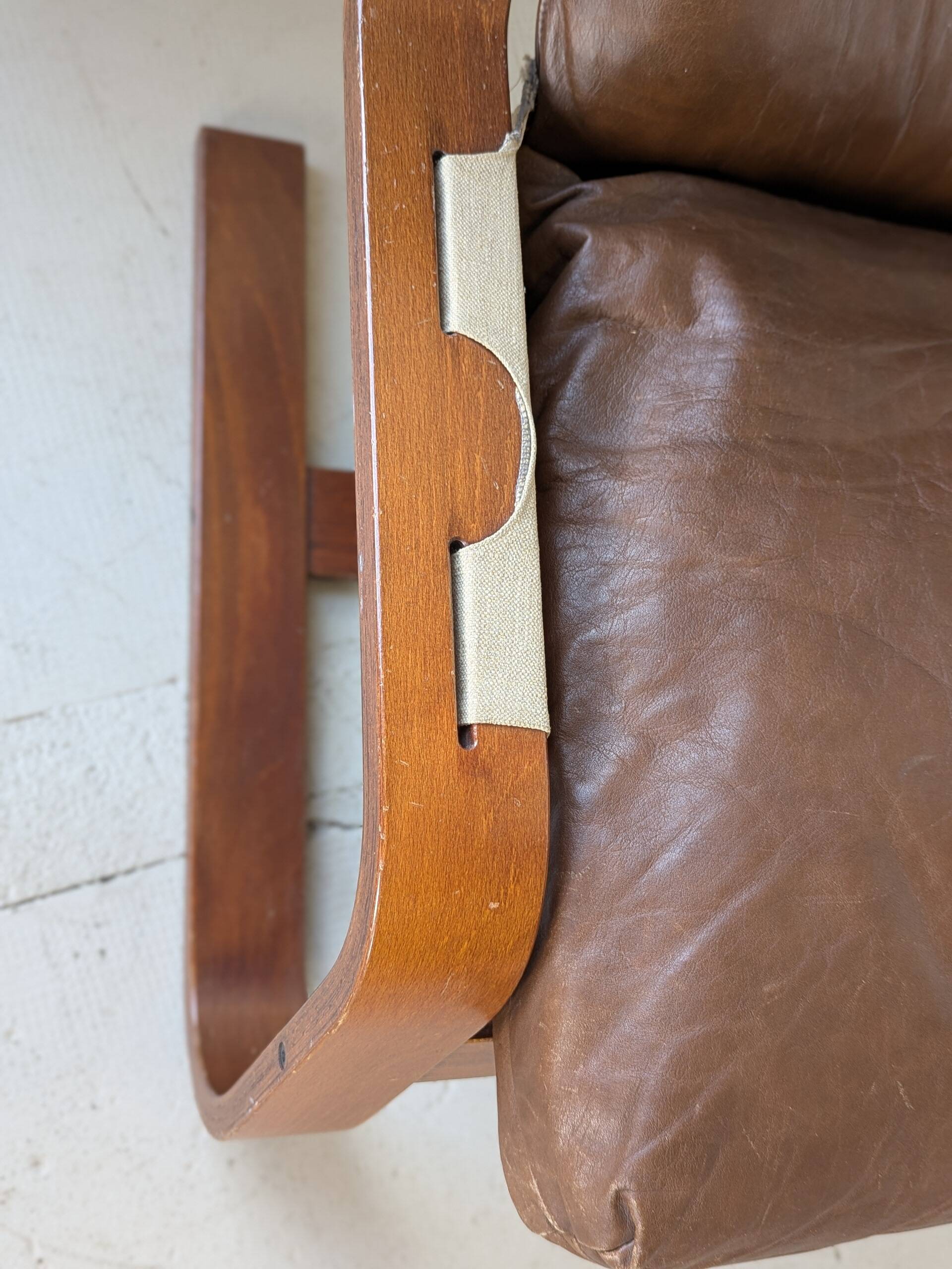 Leather and wood armchair, brutalist style.