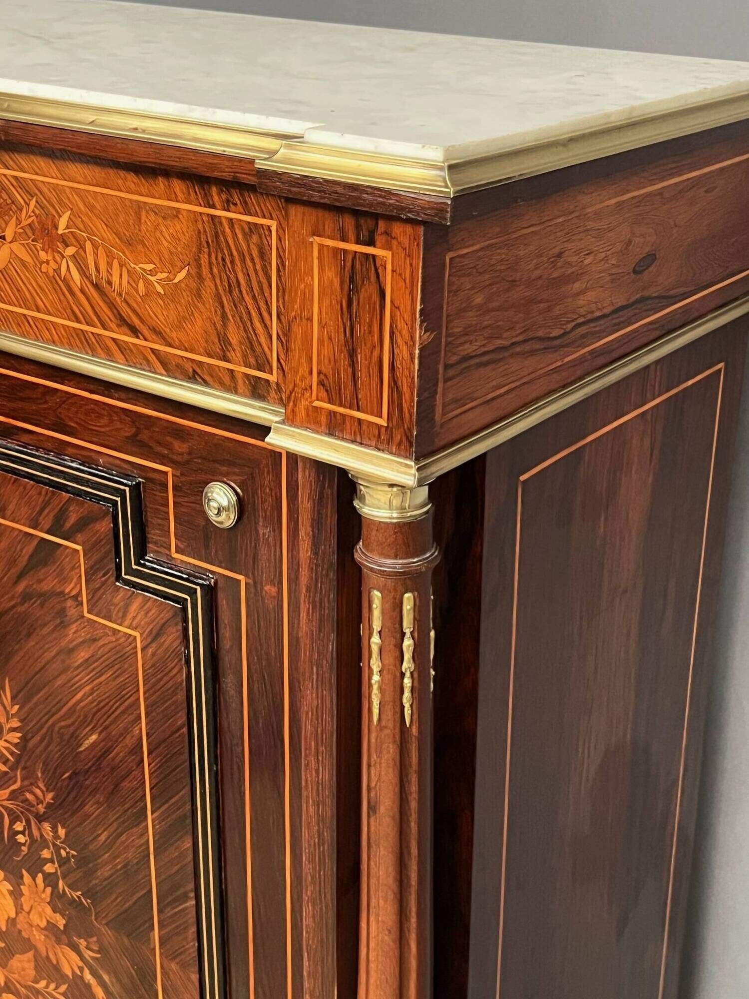 Elegant Napoleon III style commode with fine marquetry, gilded bronze mounts, and a marble top.