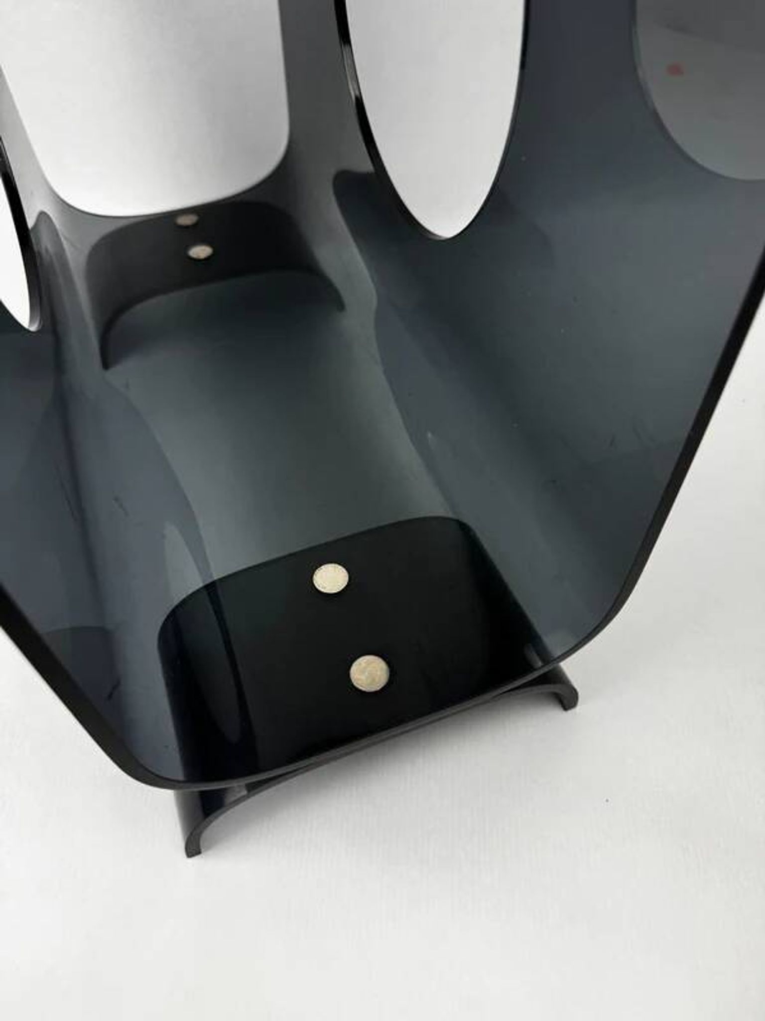 Vintage 1970s smoked plexiglass magazine rack, minimalist design.