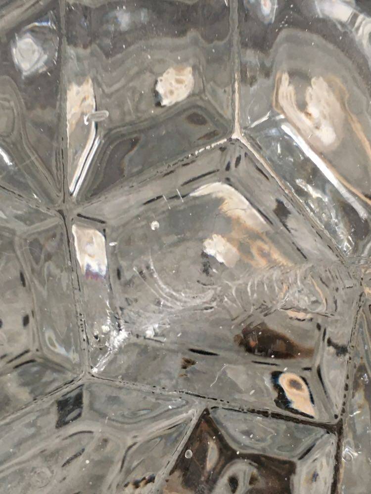 Round ceiling or wall lamp in worked glass. Gray metal support