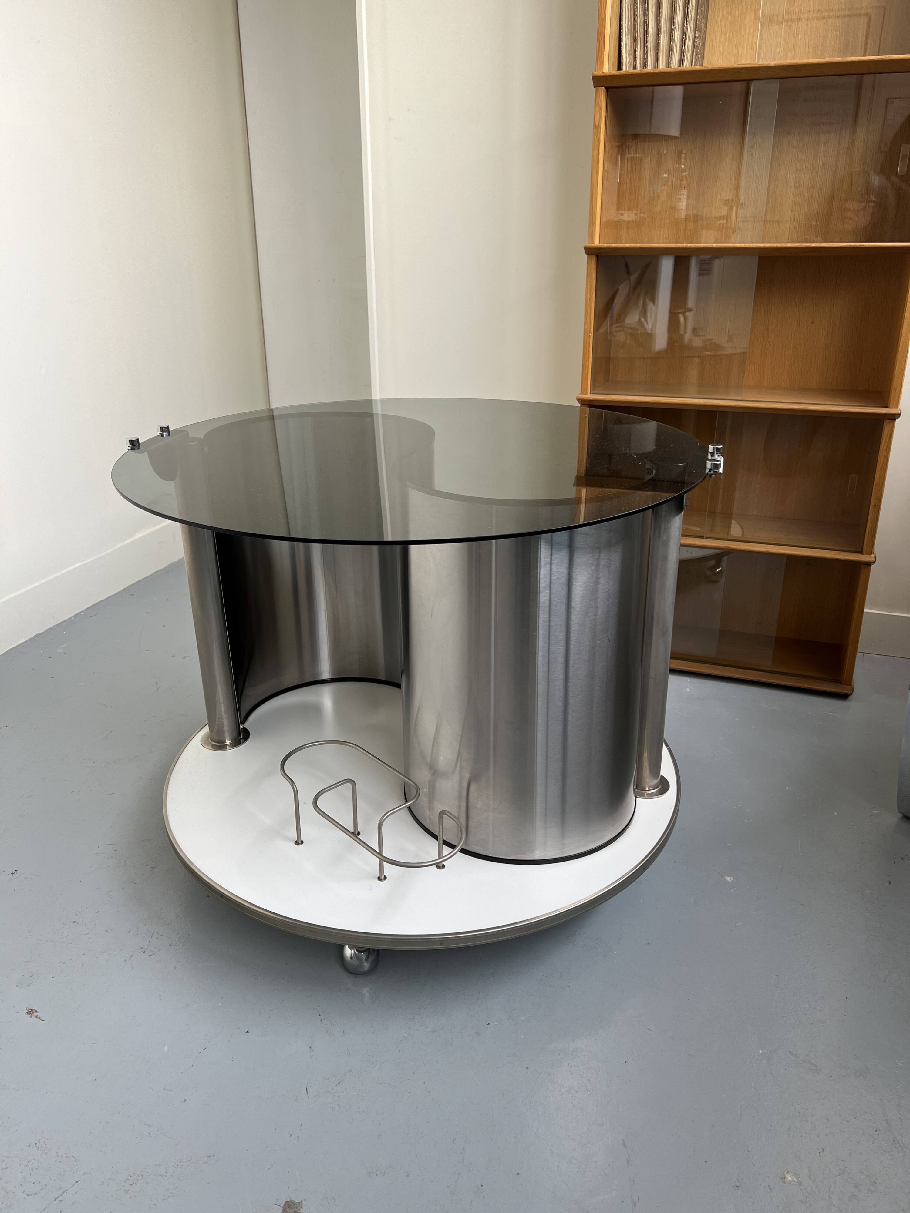 Vintage metal and smoked glass coffee table on casters bar