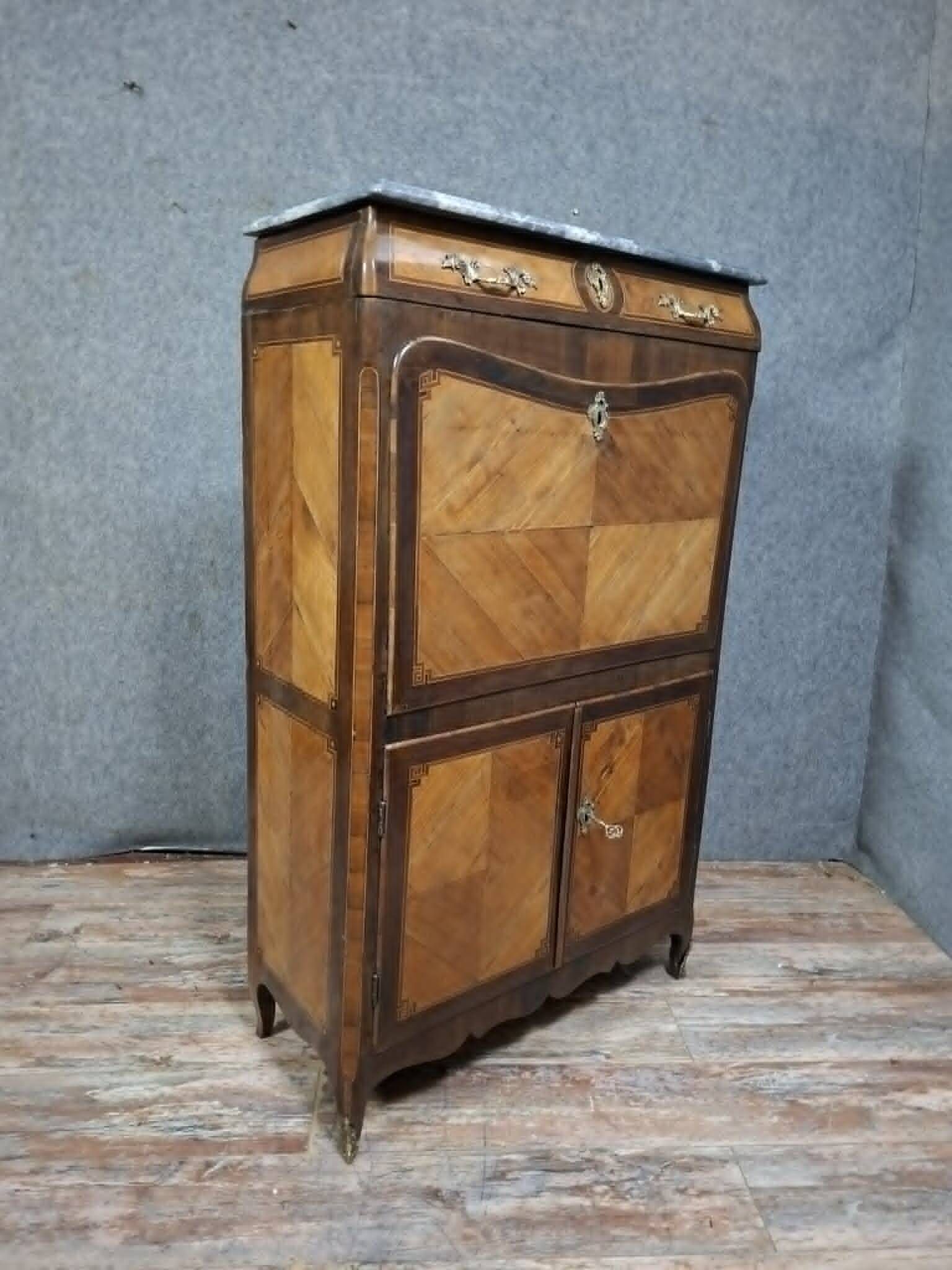 Louis XV period secretary in marquetry and veneer, 18th century.