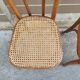 Pair of vintage bistro chairs in curved wood and caning.