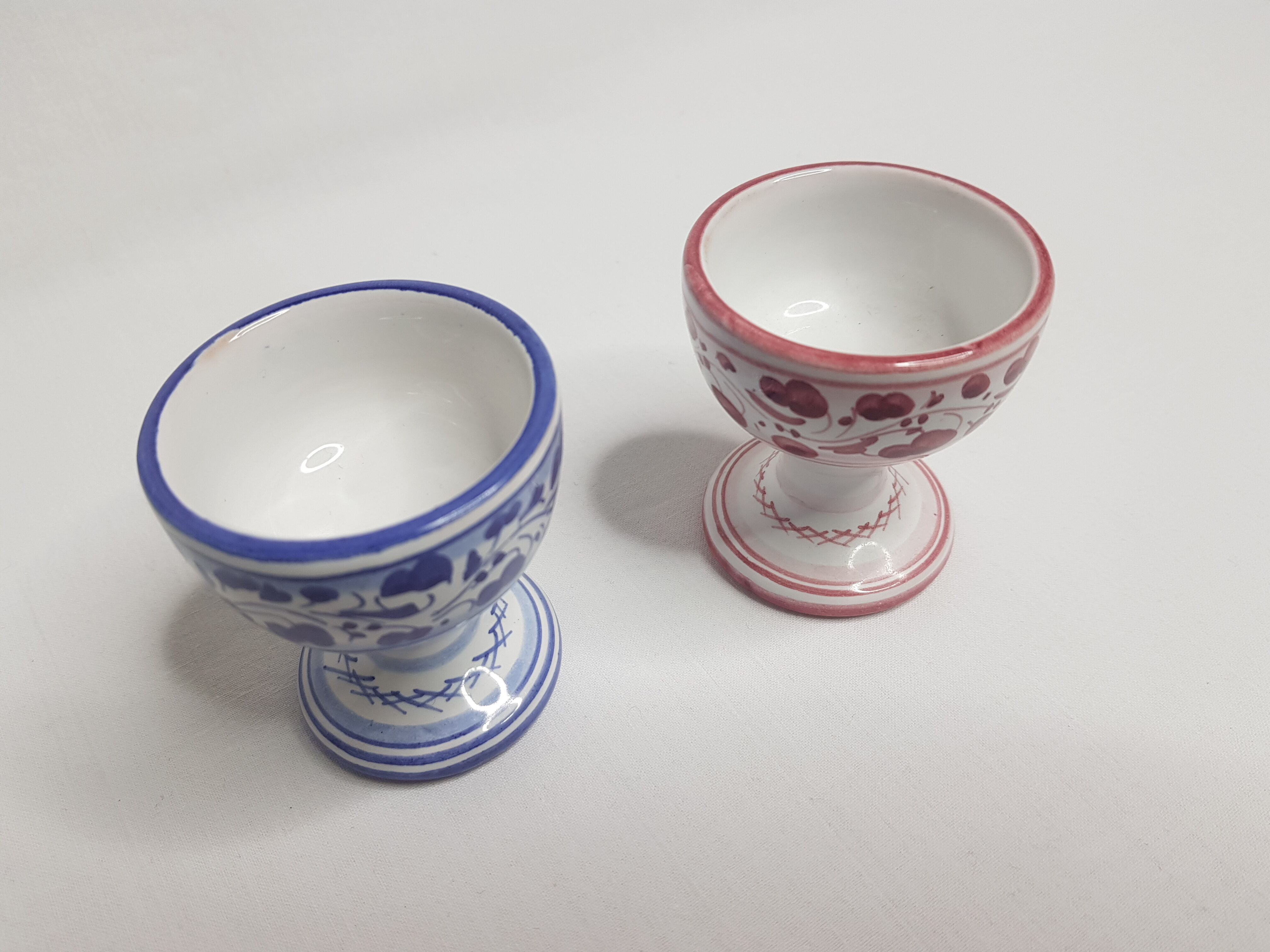 Pair of hand-decorated blue and garnet cockroaches signed "Siena Italy"