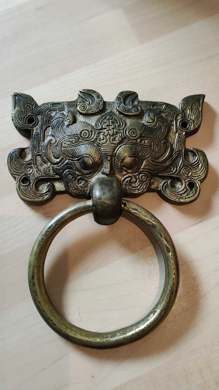 Ancient door knocker, taotié mask, shang dynasty. in bronze golden patina