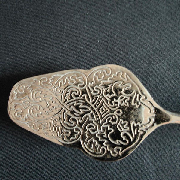 Engraved metal cake pliers