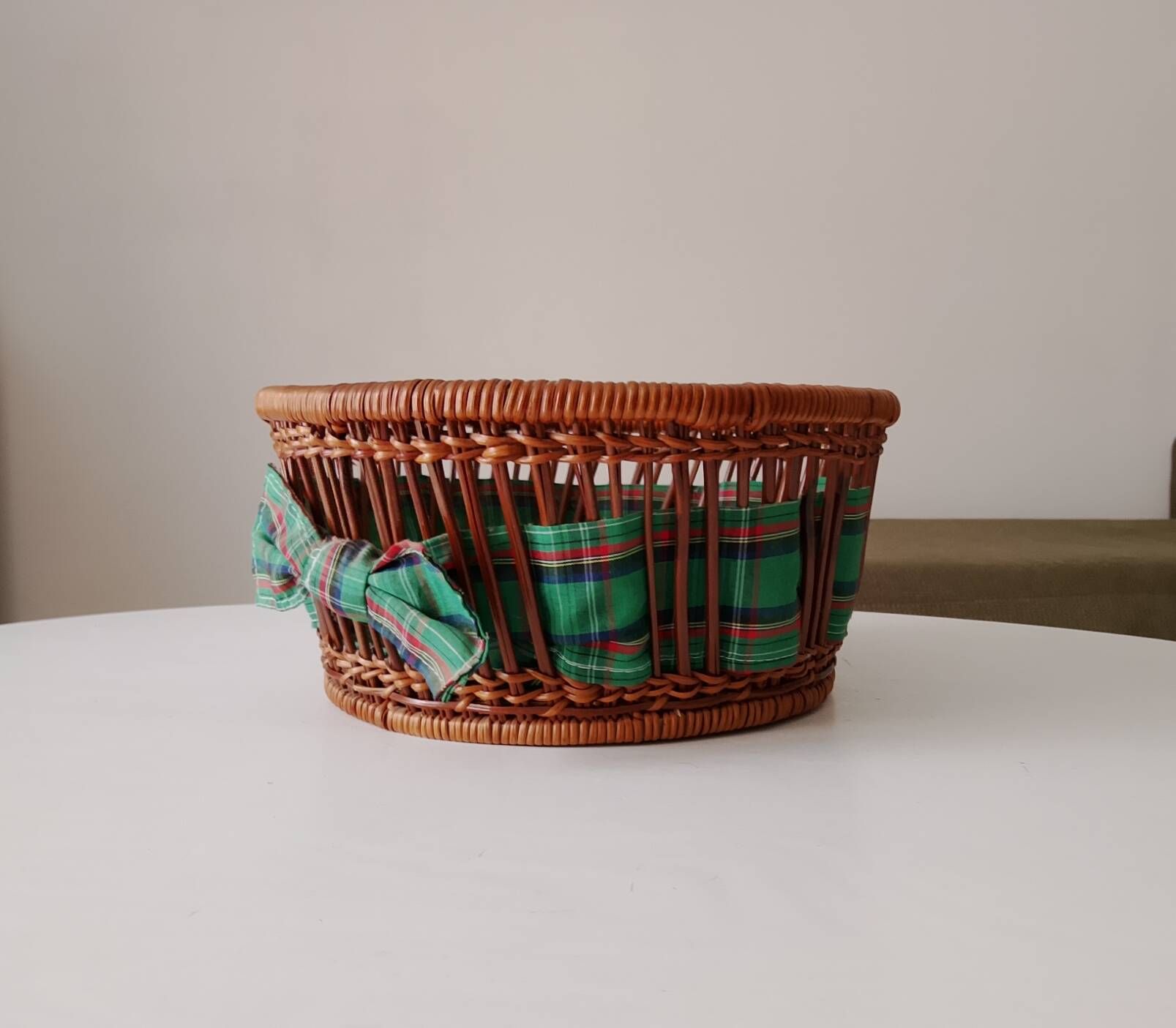 Vintage wicker and rattan basket with tartan fabric.