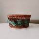 Vintage wicker and rattan basket with tartan fabric.
