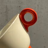 Two old orange handle cups