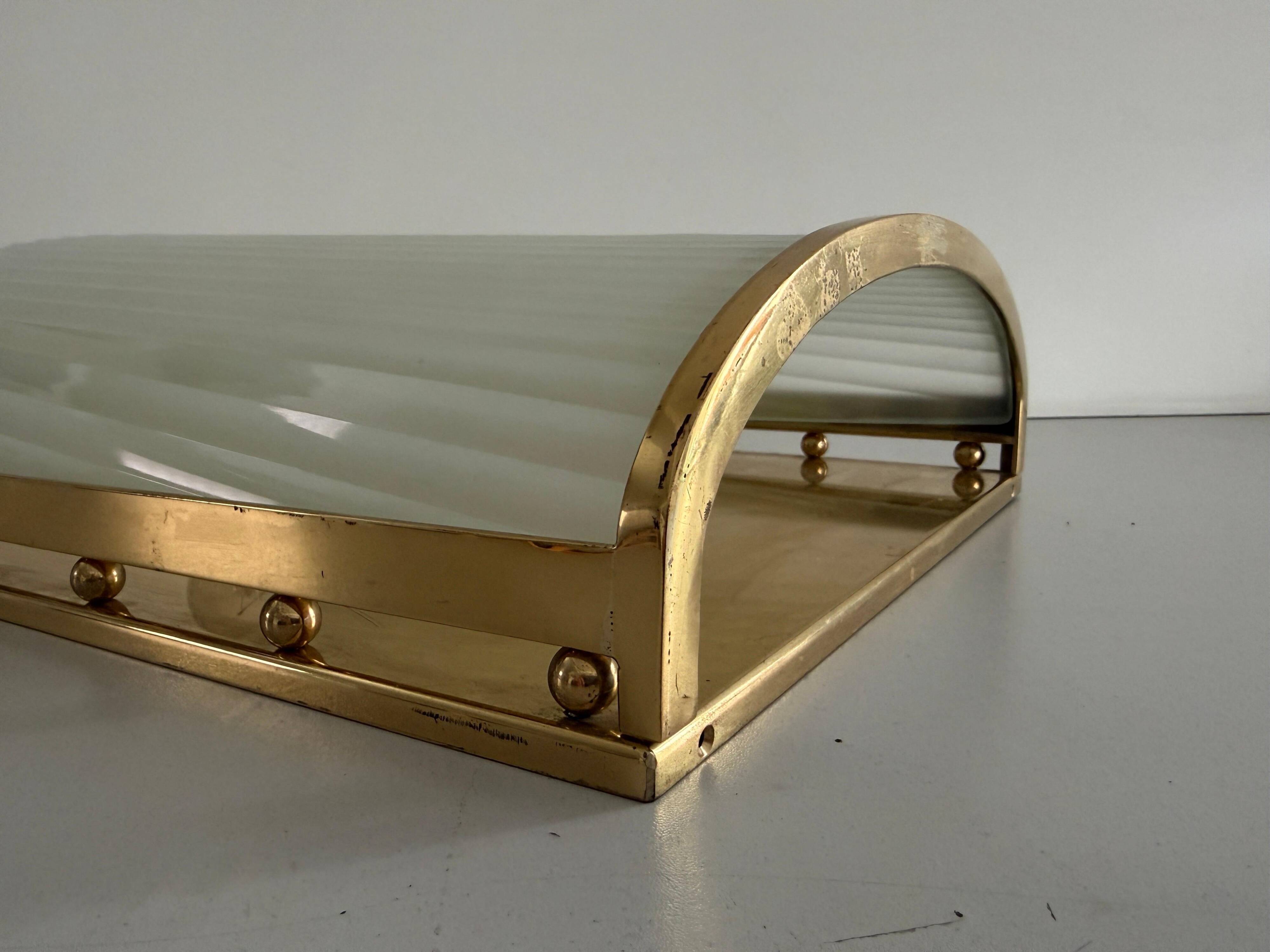 Large heavy glass wall light with a brass frame from the mid-century, 1950s, Italy.