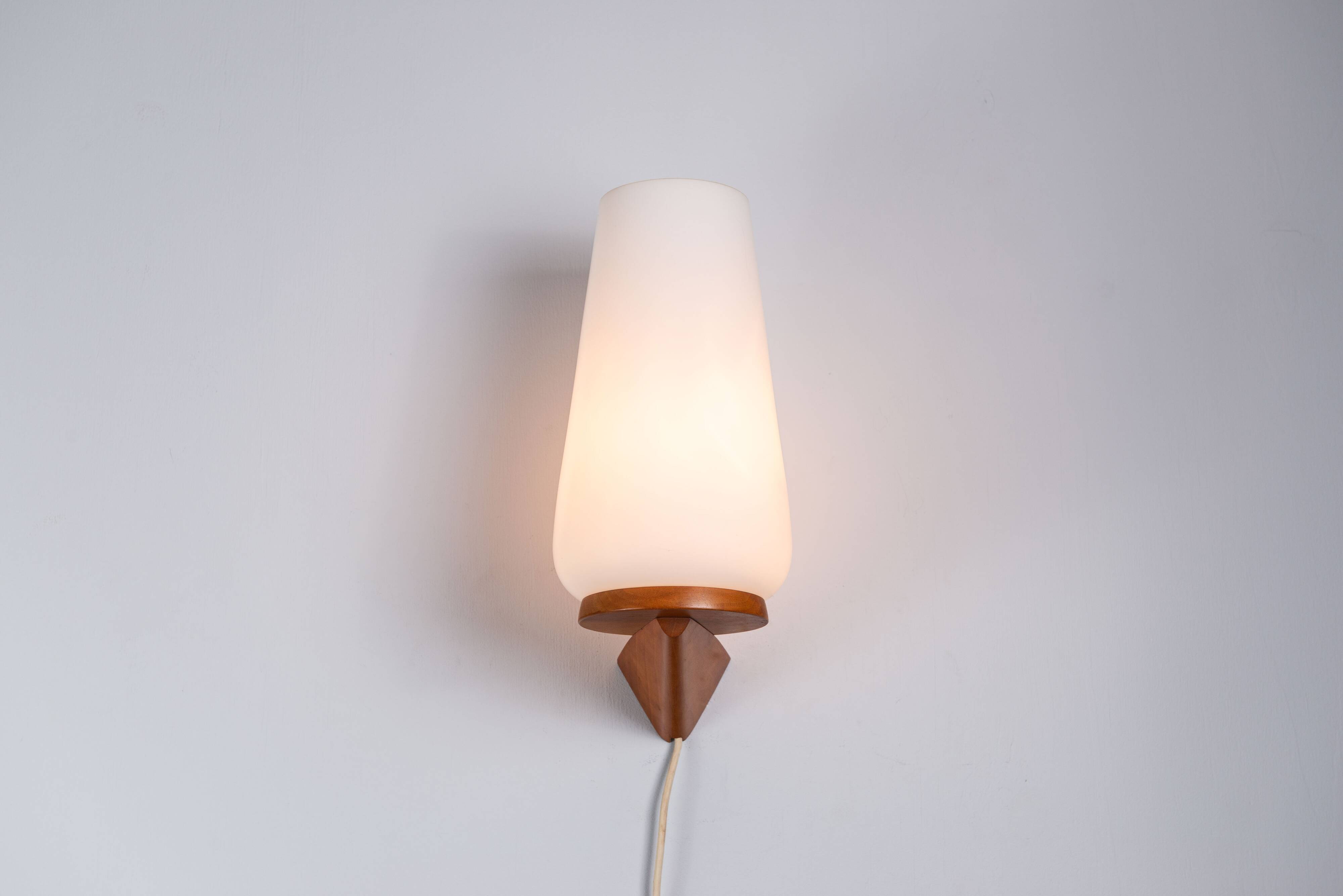 Wall lamp with opal glass shade on wooden base by Philips